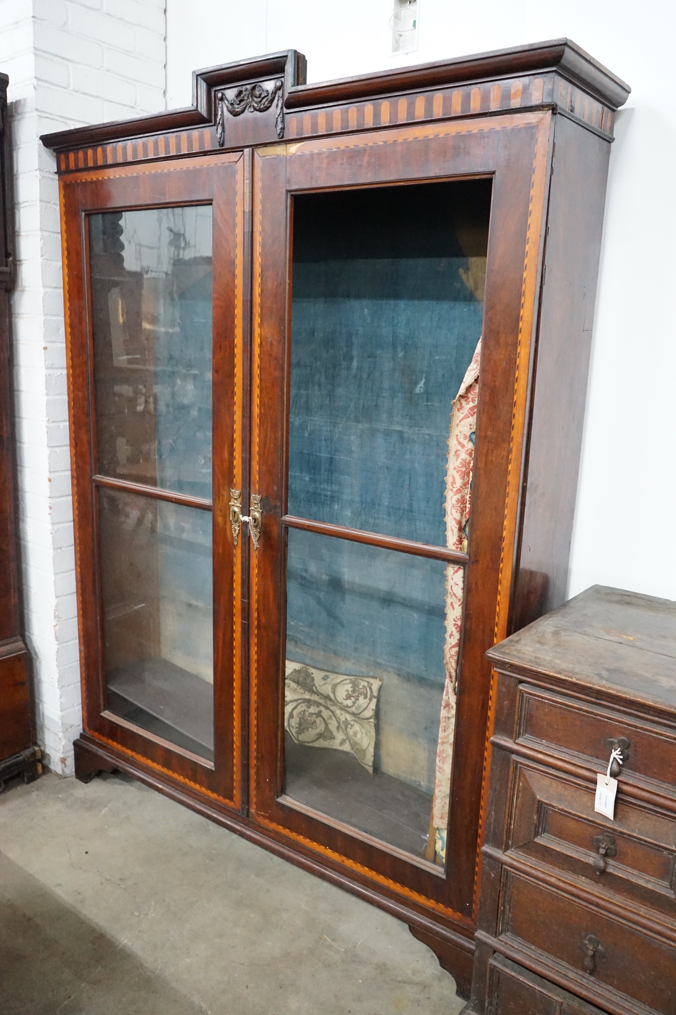 An 18th century Dutch walnut and fruitwood vitrine, with two glazed doors, width 148cm, depth 35cm, height 202cm